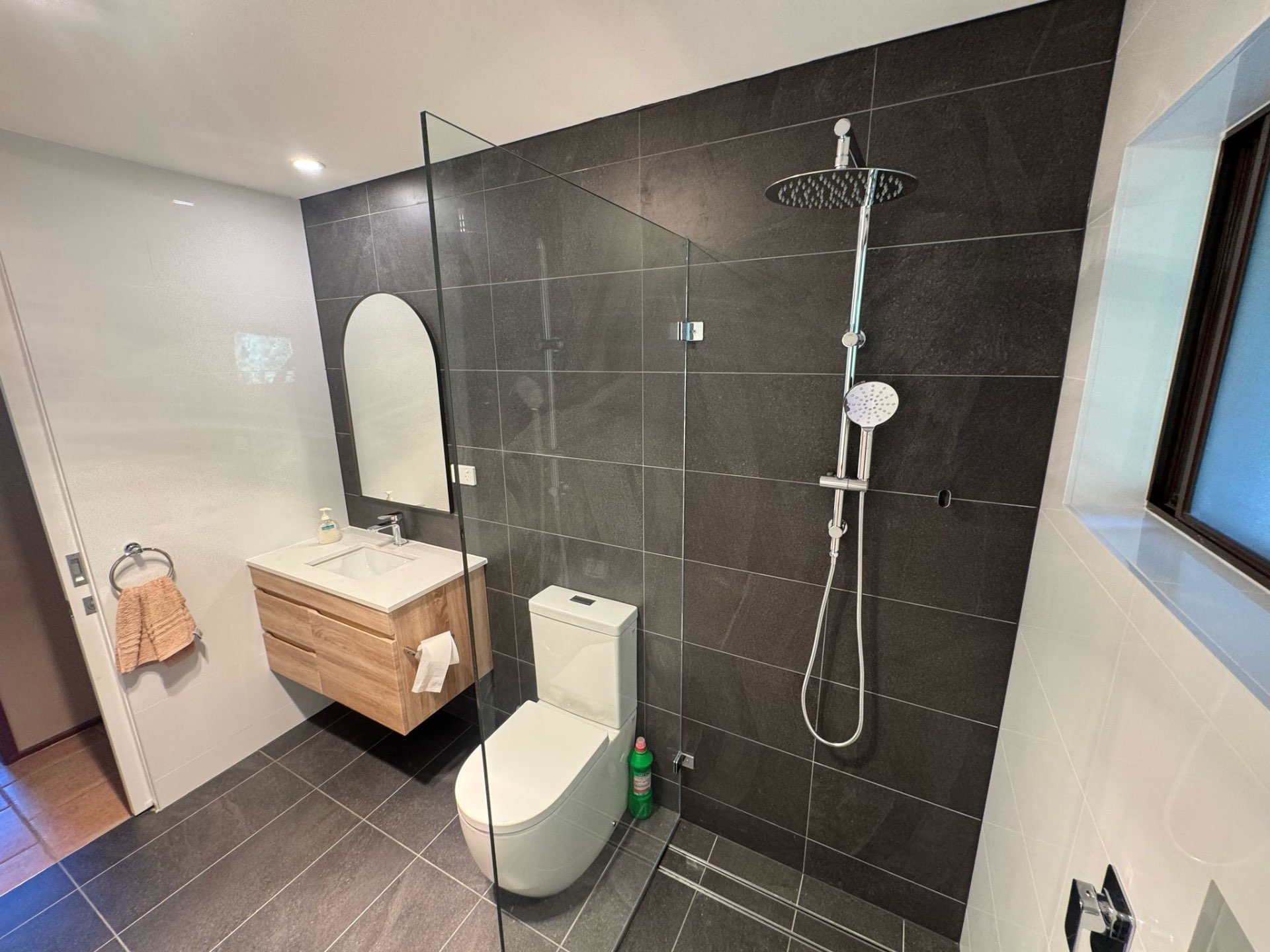 Bathroom renovation with walk-in rainfall shower and floating vanity by Endeavour Plumbing Group